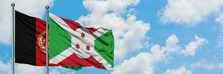 Afghanistan and Burundi flag waving in the wind against white cloudy blue sky together. Diplomacy...