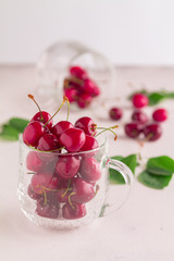 Still life. Glass cup with ripe red cherries
