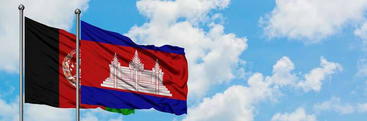 Afghanistan and Cambodia flag waving in the wind against white cloudy blue sky together. Diplomacy...