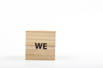 Wooden cubes with the inscription we on a white background