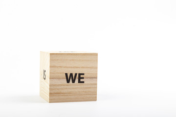Wooden cubes with the inscription we on a white background