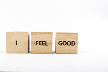 Wooden cubes with the inscription I Feel Good on a white background