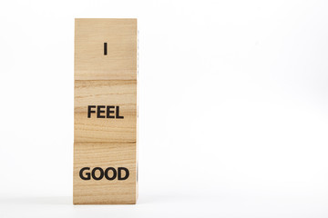 Wooden cubes with the inscription I Feel Good on a white background