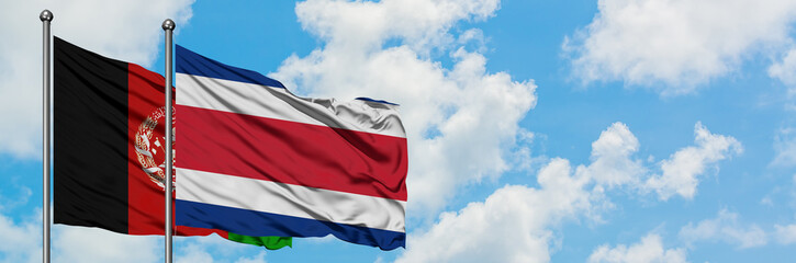 Afghanistan and Costa Rica flag waving in the wind against white cloudy blue sky together. Diplomacy concept, international relations.