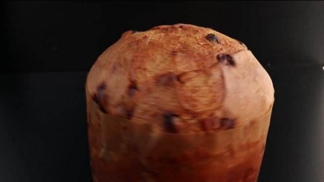 Tasty Italian holiday cake close-up  Traditional Italian milanese Christmas panettone on white/black background