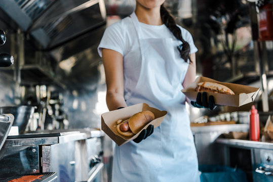 Cropped view of woman holding carton plates in food truck