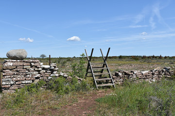 Wooden stile by an old dry stone wall