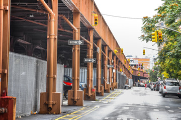 Obraz premium Bottom view of Elevated train track nyc. Buildings in the background in a foggy day. NYC, USA.