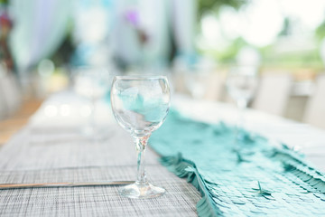 outdoor lunch in the sun. Laid blue table with wine glasses