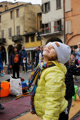 Cute smiling little girl portrait on winter day in the street. Happy children, childhood concept.