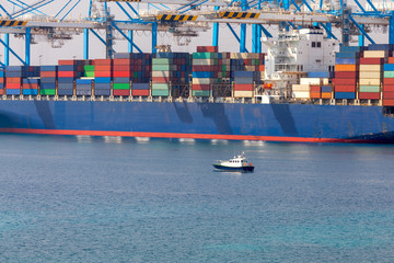 A large container ship is loaded in the cargo port of Malta.