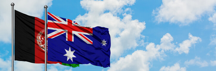 Afghanistan and Heard Island and Mcdonald Islands flag waving in the wind against white cloudy blue...