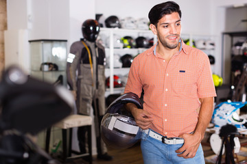 Portrait of male customer who is posing in new helmet