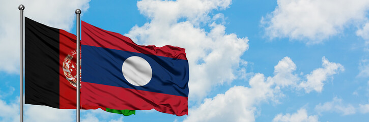 Afghanistan and Laos flag waving in the wind against white cloudy blue sky together. Diplomacy...