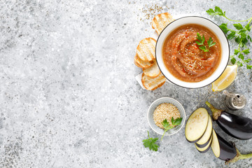 Eggplant hummus with ingredients for cooking. Traditional vegan arabic aubergine appetizer. Baba...