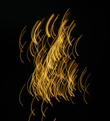 bright stripes of light moving on the black background in motion blur