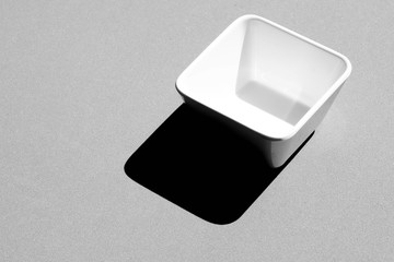 Square Bowl empty on grey background - monochrome