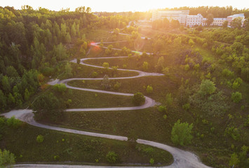 Aerial top vew of winding road in the city, drone shot