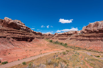 Landscape of red stone bluffs in a canyon in Bluff, Utah