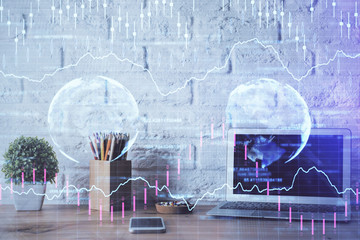 Obraz premium Financial graph colorful drawing and table with computer on background. Double exposure. Concept of international markets.