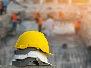 White and yellow hard safety wear helmet hat in the project in construction site