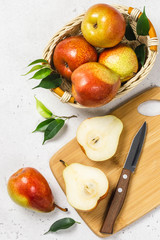 Ripe colourful pears sliced on cutting board. Top view, space for text.