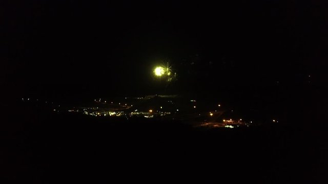 Wide aerial, fireworks explode over Corbin