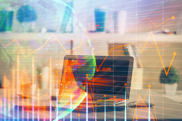Financial chart drawing and table with computer on background. Double exposure. Concept of...