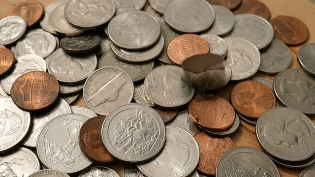 American money. Large pile of coins of American cents of different denominations. Coins are falling from above. Financial background. Selective focus. Close-up.