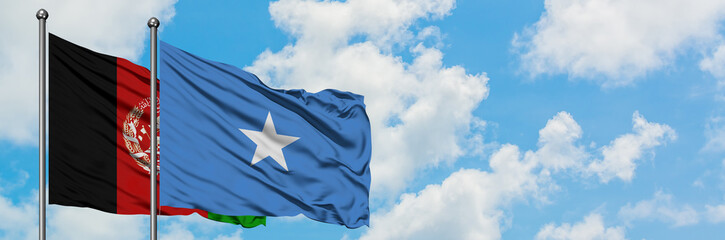 Afghanistan and Somalia flag waving in the wind against white cloudy blue sky together. Diplomacy...