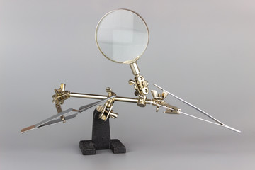 soldering helping hand isolated on gray background
