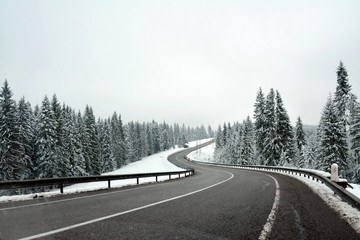 Naklejka premium a road through mountains in winter