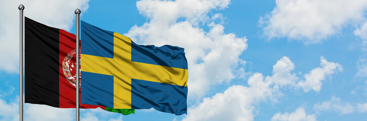 Afghanistan and Sweden flag waving in the wind against white cloudy blue sky together. Diplomacy...