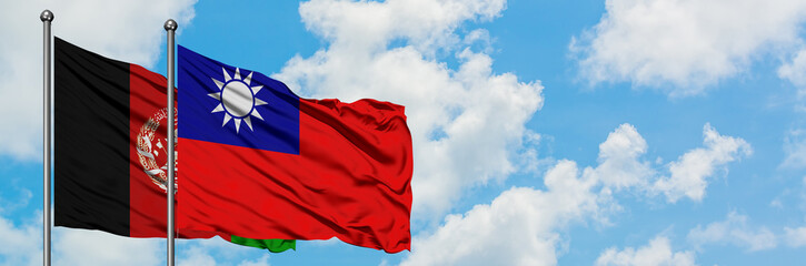 Afghanistan and Taiwan flag waving in the wind against white cloudy blue sky together. Diplomacy...