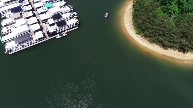 Tilt up aerial, boats docked in Laurel River Lake