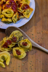 Plate of meat ravioli with tomato