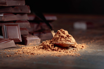 Broken  chocolate pieces and cocoa powder .
