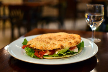 Healthy vegetarian sandwich with mozzarella, gorgonzola, mushrooms, lettuce, tomato and bread with sesame