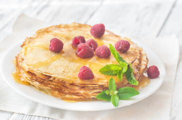 Stack of crepes with raspberries