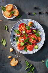 Salad of tomatoes, cucumbers, green peppers, olives, onions with