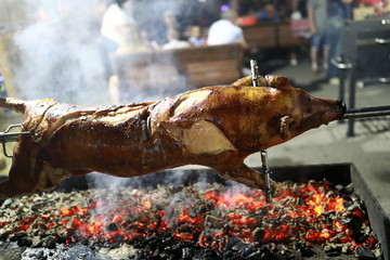 Frying piglet on spit