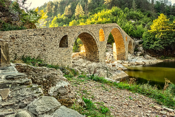 Fototapeta na wymiar Beautiful old stone bridge near Ardino, Bulgaria