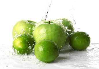 Ripe fruits with water splash on white background