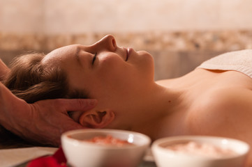 Fototapeta na wymiar Beautiful woman receiving a massage in a spa.