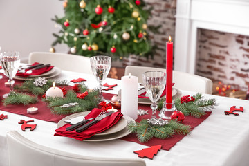 Beautiful table setting with Christmas decorations in living room