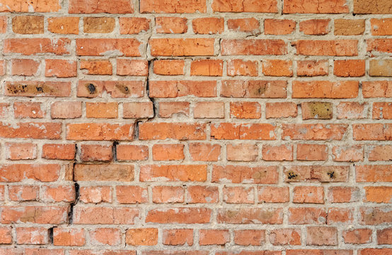 Fototapeta Background of old weathered brick wall with crack.