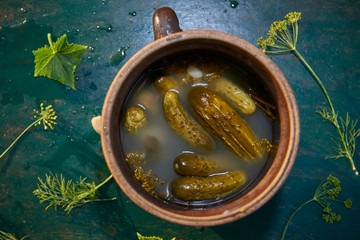 Homemade pickled cucumbers in brine with garlic, dill and horser