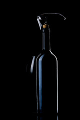 A bottle of wine. Wine glass. Natural cork. Metal corkscrew.