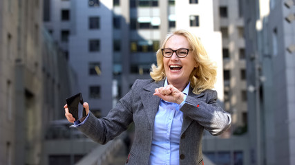 Happy office worker dancing celebrating good news, career achievement, success