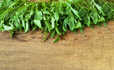 Arugula on old wooden boards. Natural surface texture for design background
